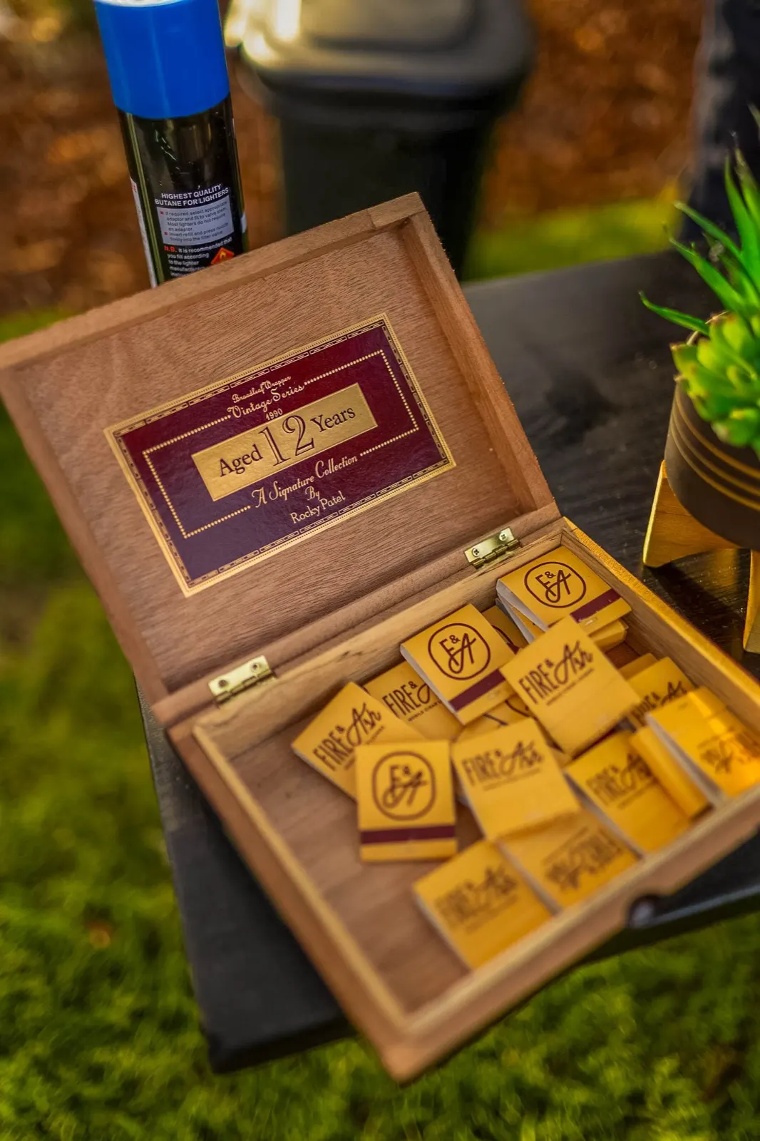 Fire and Ash branded humidor box with cigars and custom matchboxes