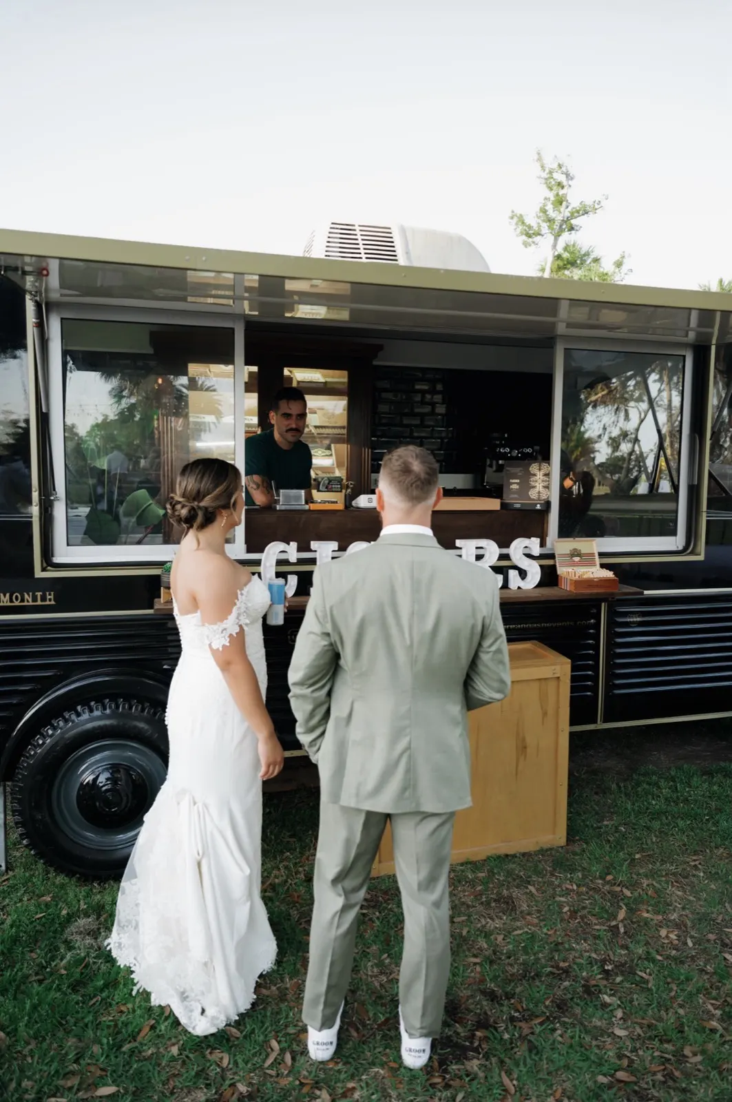 Bride and groom at the Fire and Ash cigar truck on their wedding night