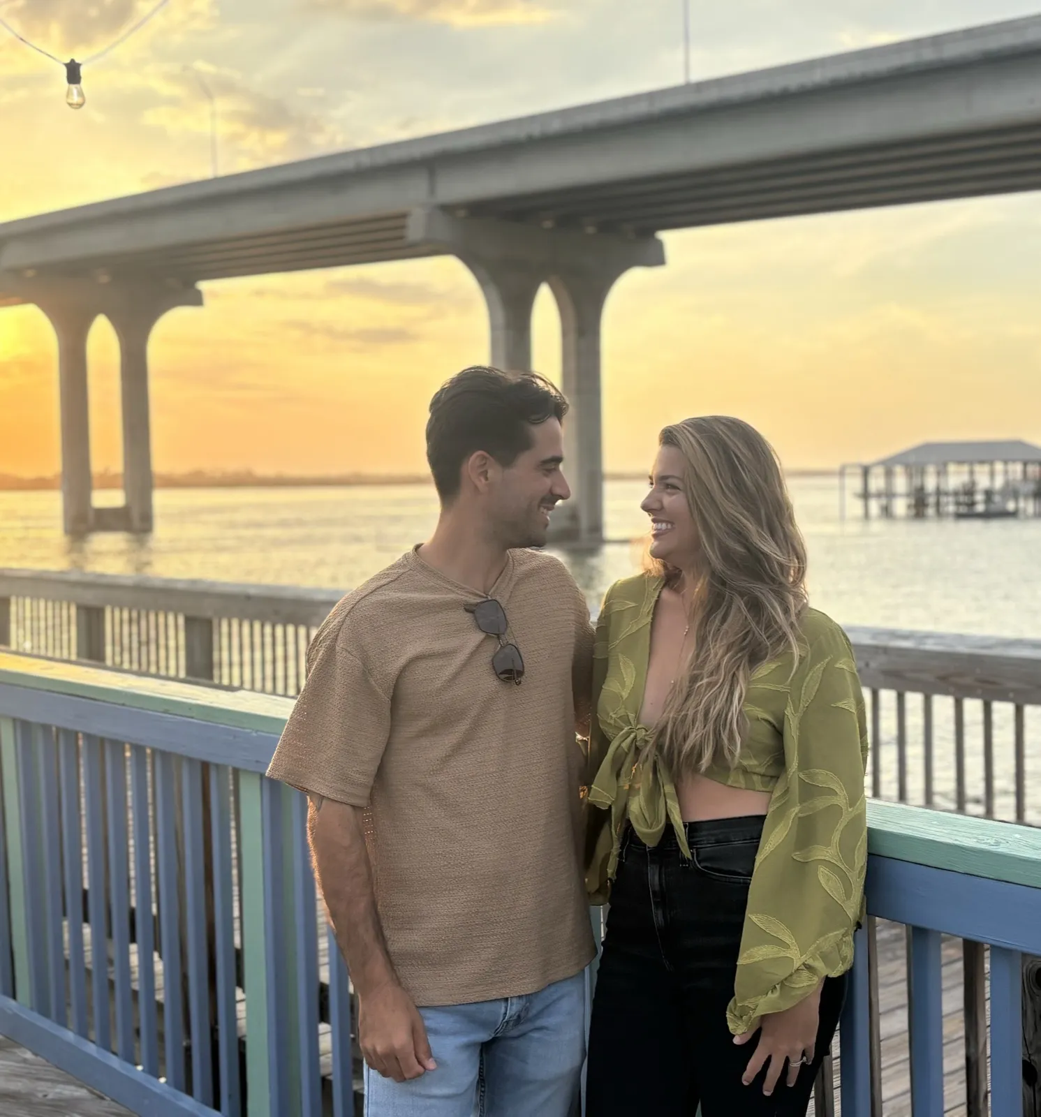 Founders Carlos and Hannah Lopez together at sunset on a Florida waterfront