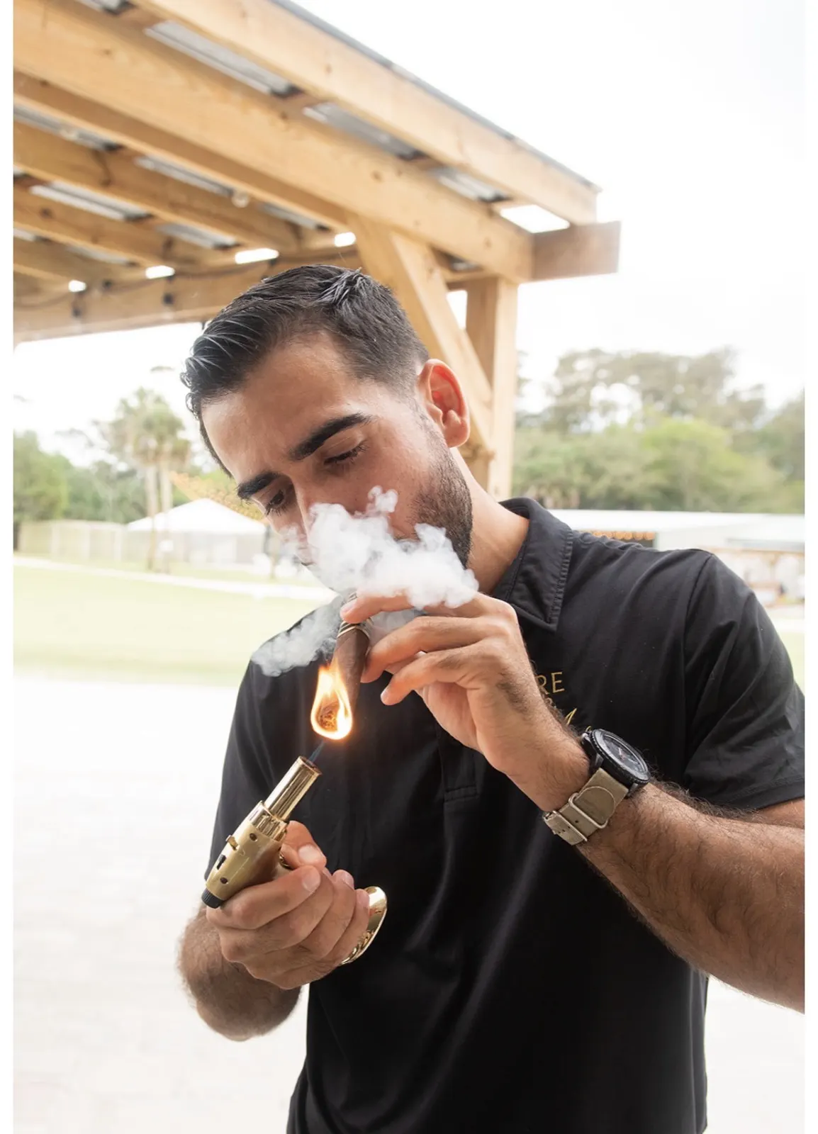 Carlos lighting a cigar
