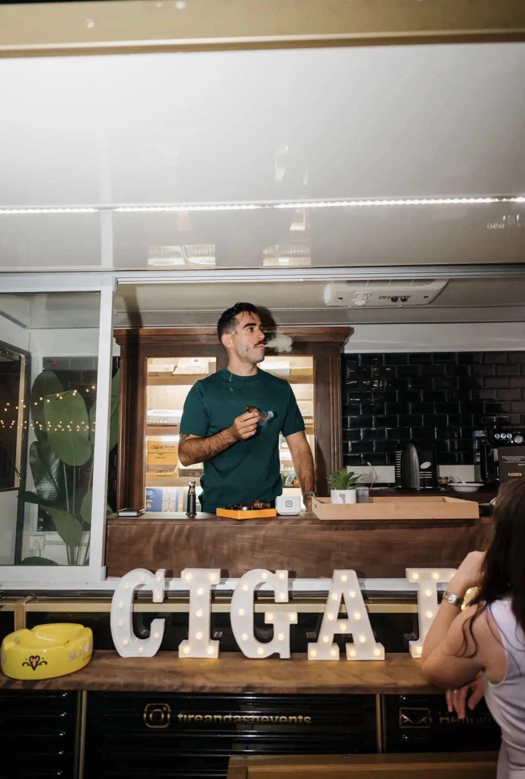 Young attendant serving at the cigar letters bar