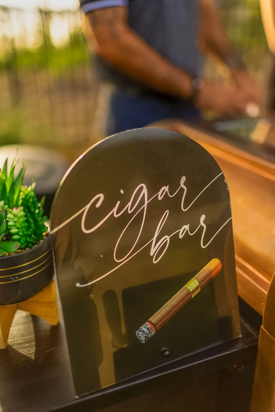 Elegant script cigar bar sign on the Fire and Ash counter