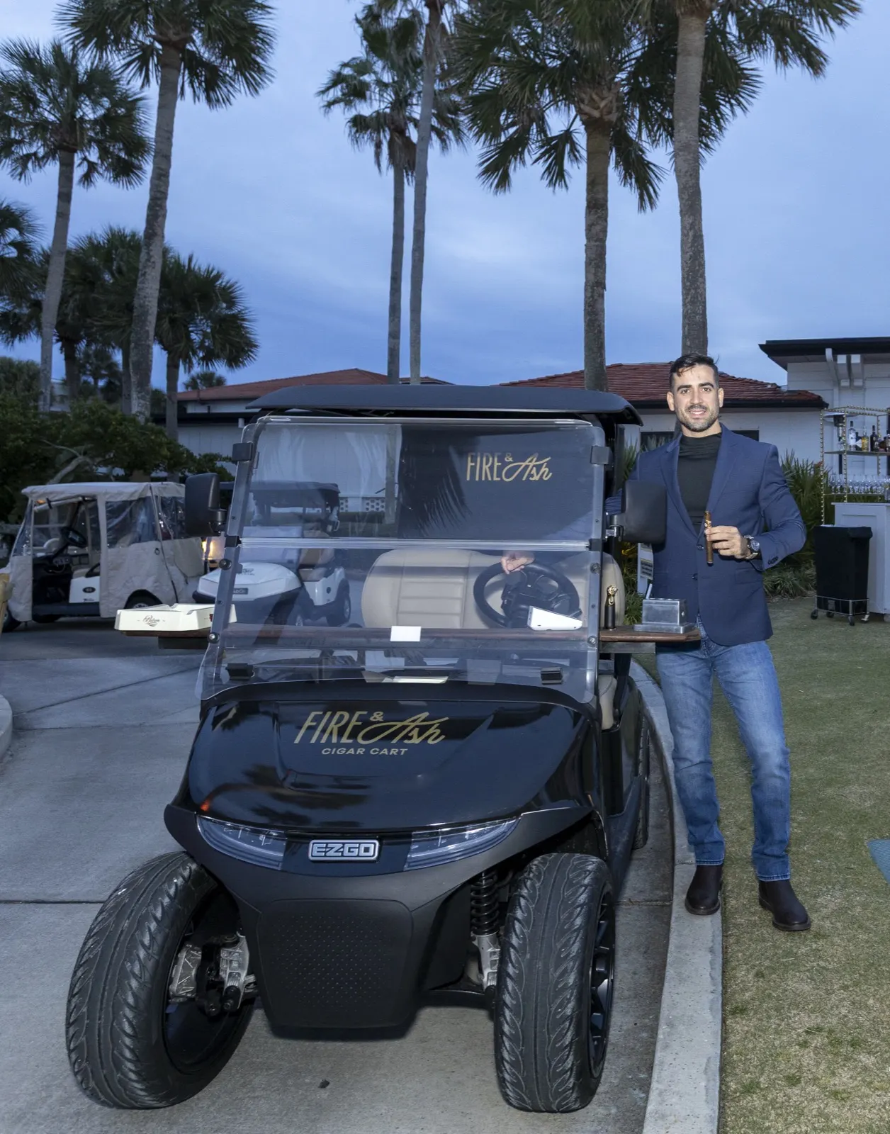 Front of the black Fire and Ash cigar golf cart with custom headlights