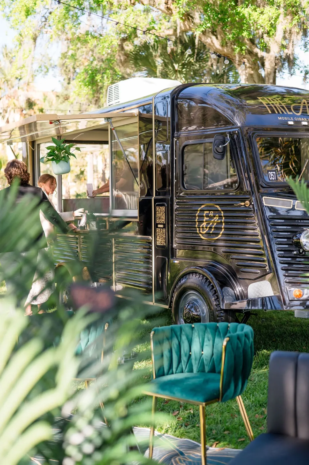 Fire and Ash cigar truck with lounge seating styled under Florida oaks