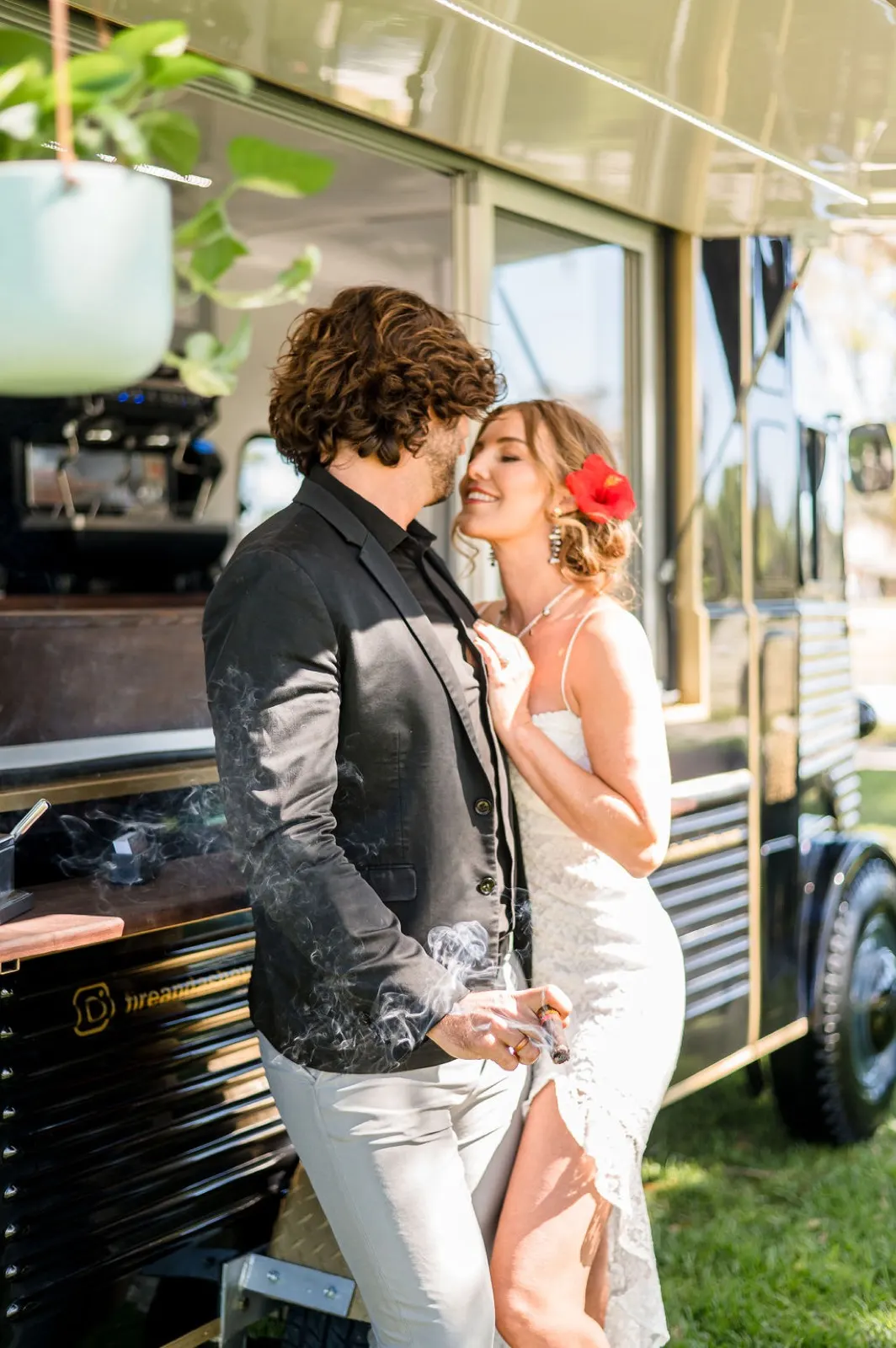 Couple kissing beside the vintage cigar truck