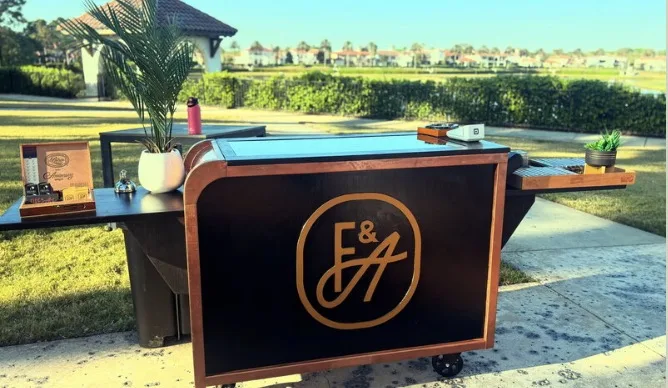 Fire and Ash monogrammed bar cart set up on a Florida course at sunrise