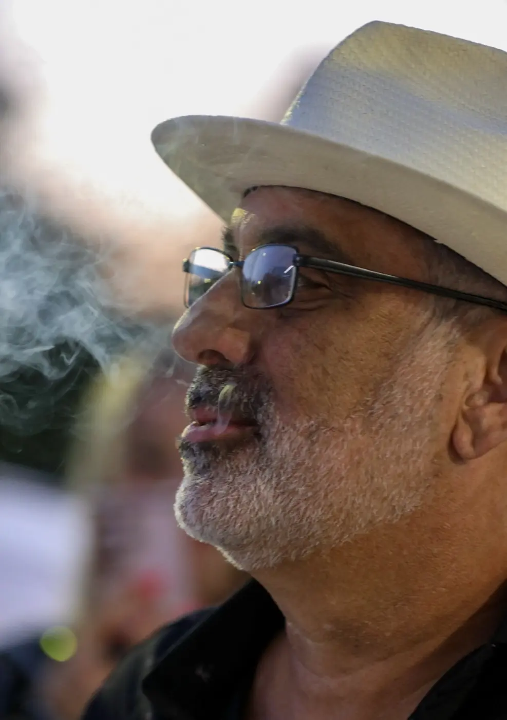 Guest in a fedora enjoying a cigar