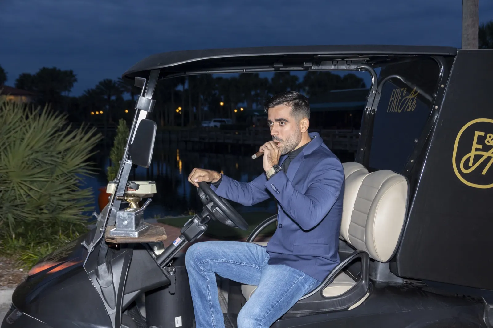 Guest relaxing in the cigar golf cart at an evening event