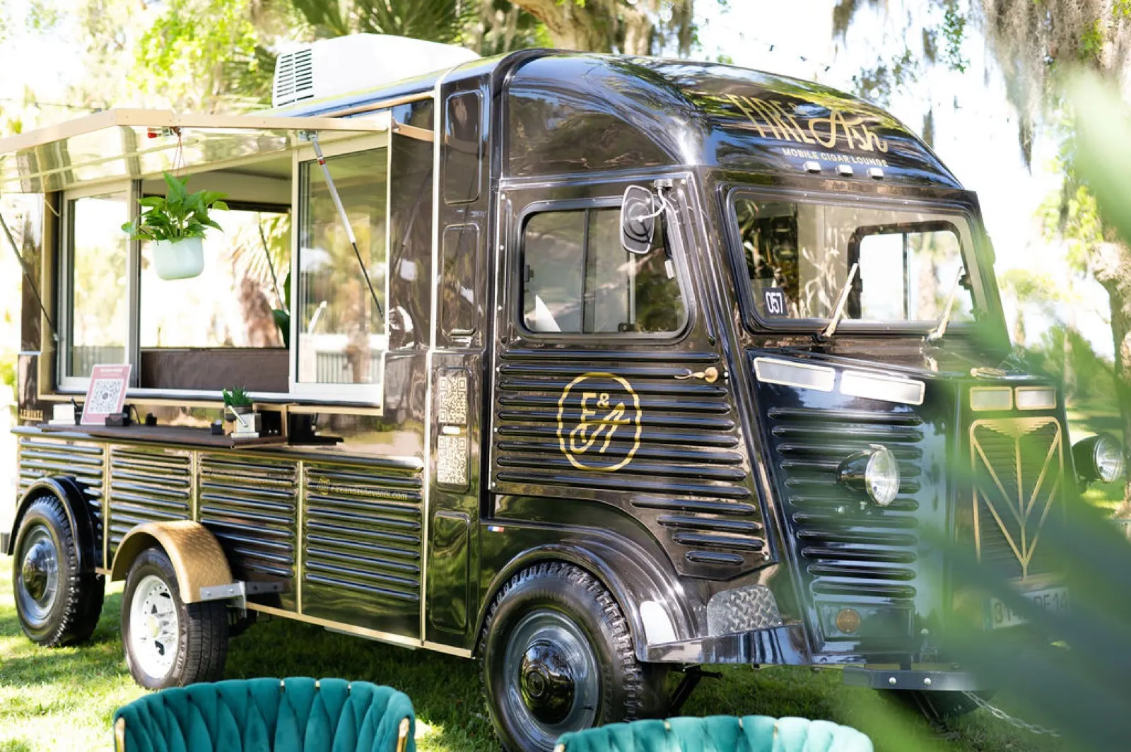 The vintage Fire and Ash cigar truck styled in a garden venue